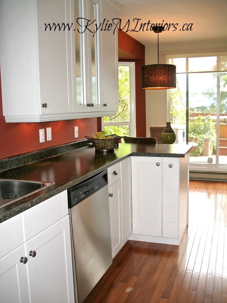 kitchen painted boxcar red by benjamin moore with white cabinets and dark granite look laminate countertop labrador granite with oak floors