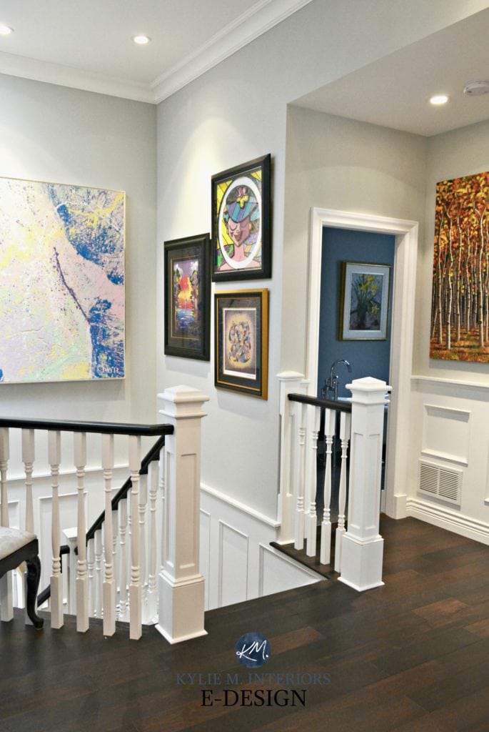 Staircase with white spindles, black hand rail. Artwork. Dark wood flooring, Stonington Gray paint colour. Kylie M E-design, virtual online decorating, colour consultant