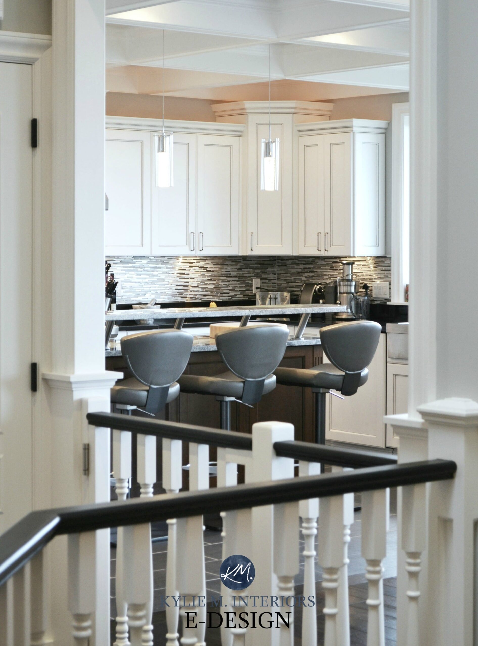 White kitchen, gray stool, black handrail on white stairs. Kylie M E-design, online decorating, virtual packages
