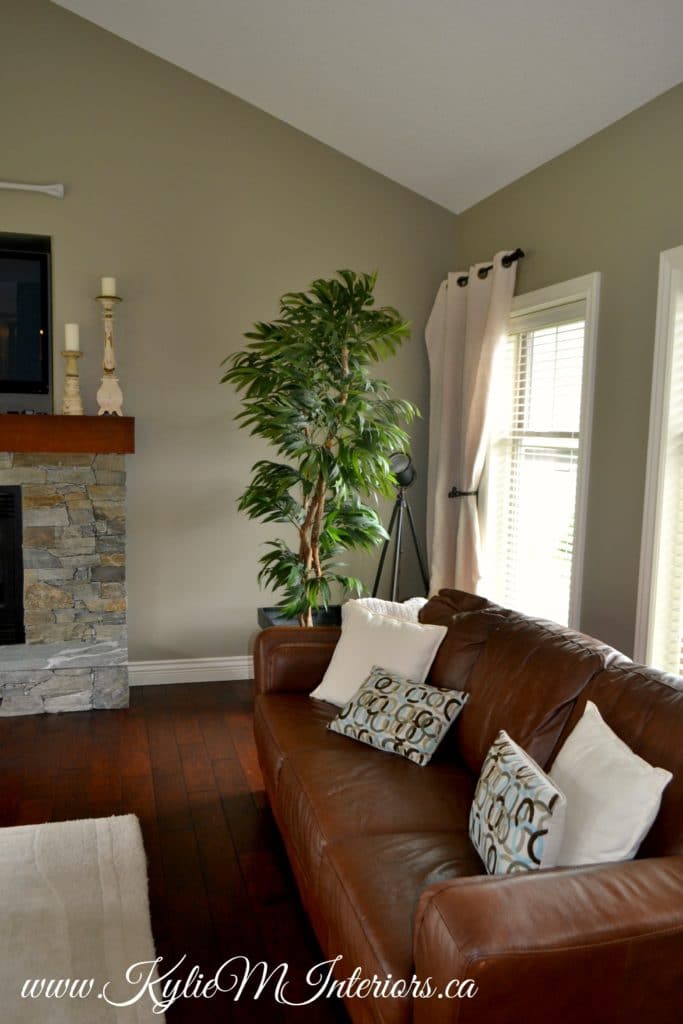 living room benjamin moore gray mirage with slate stone fireplace and dark cherry wood floors and brown leather couch
