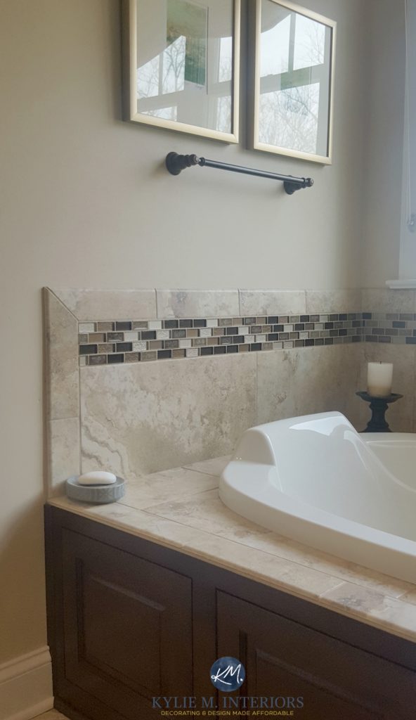 Sherwin Williams Kilim Beige in a bathroom with beige toned tile and soaker tub with dark wood surround. Kylie M Interiors E-design