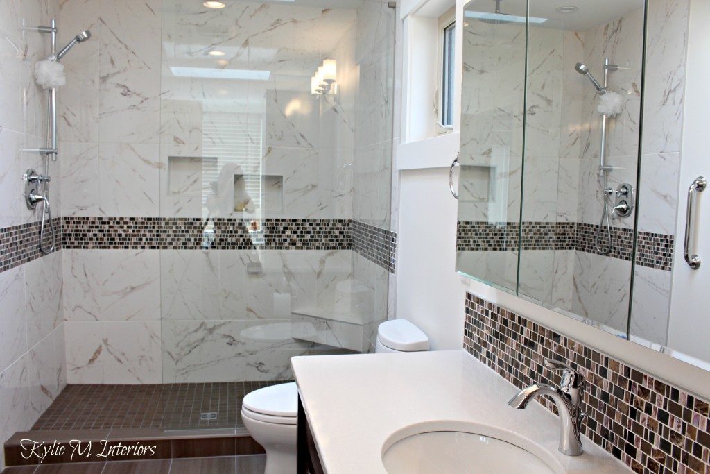 walk in shower in bathroom with pink and brown mosaic tile, marble look shower surround, white quartz and cloud white walls