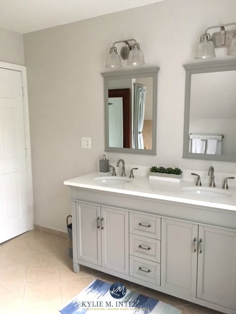Benjamin Moore Balboa Mist in bathroom with beige tile and gray and white vanity. Kylie M INteriors E-design and online colour consulting services
