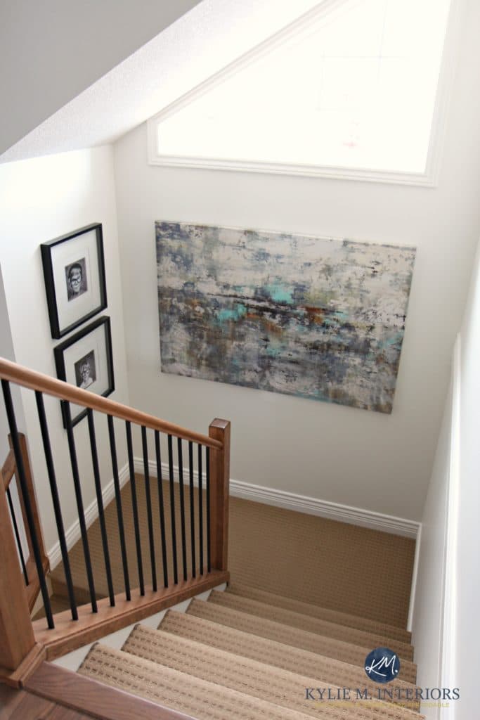 Sherwin Williams Creamy is a great paint color for home staging or selling. As shown in stairway with wood and metal railing by Kylie M Interiors E-design
