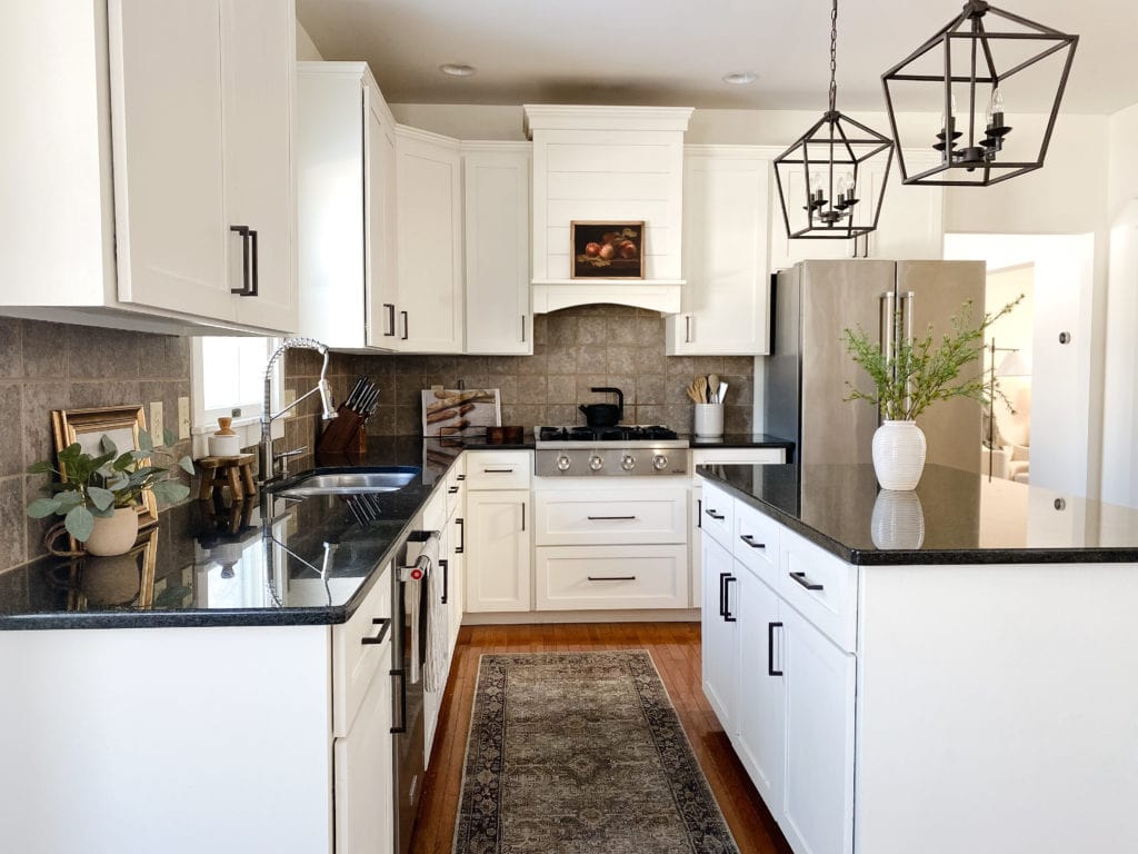 Sherwin Williams Alabaster warm white painted wood cabinets, black granite countertop, wood floor. beige backsplash tile, Kylie M Interiors Edesign, Jenna Christians home