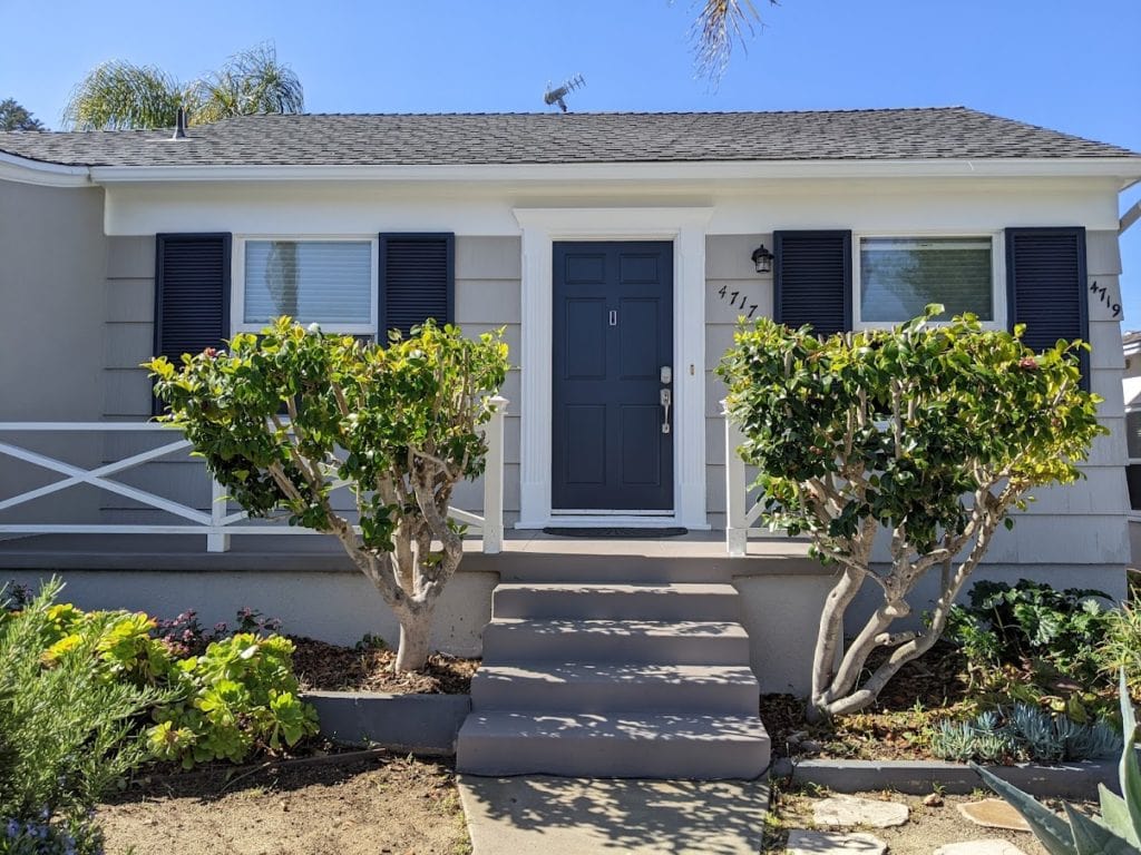 Sherwin Williams Requisite Gray exterior siding update, Pure White trim and Cyberspace on shutters and front door. Kylie M INteriors Edesign