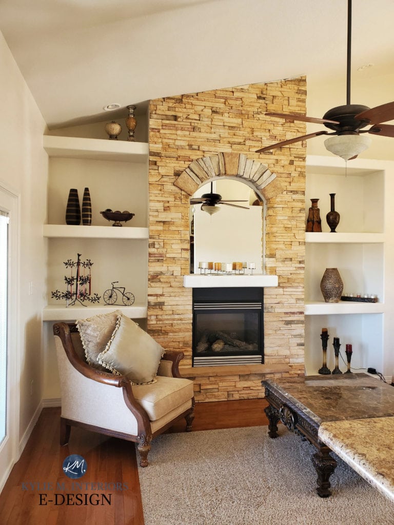 Living room with Tuscan style gold yellow stone fireplace and built in shelves. Walls painted warm crema beige paint colour, Sherwin Williams Divine White, Kylie M Interiors Online paint colour