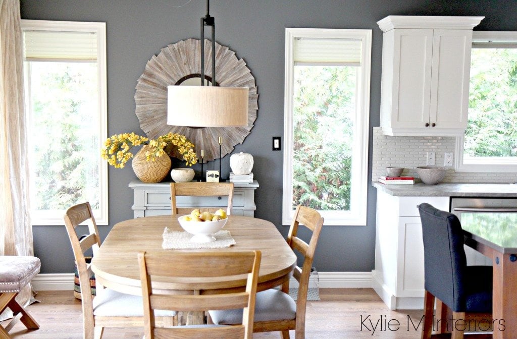 Open layout farmhouse style dining room and kitchen with Benjamin Moore Steel Wool, Cloud White and round oak table with home decor in country style