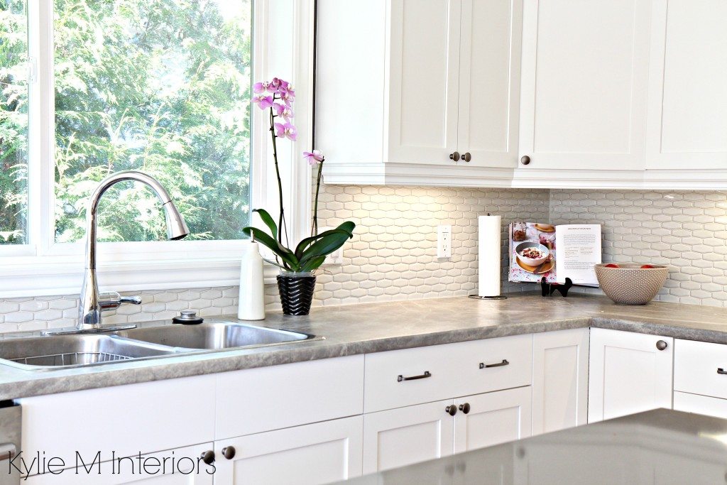 hexagon subway tile backsplash. Maple cabinets painted Cloud White, soapstone formica countertops and gray quartz with kitchen decor