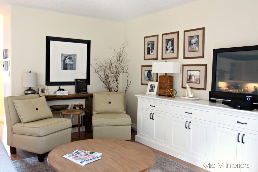 Living room layout with 2 chairs, family photo gallery above TV cabinet and home decor that has reclaimed wood