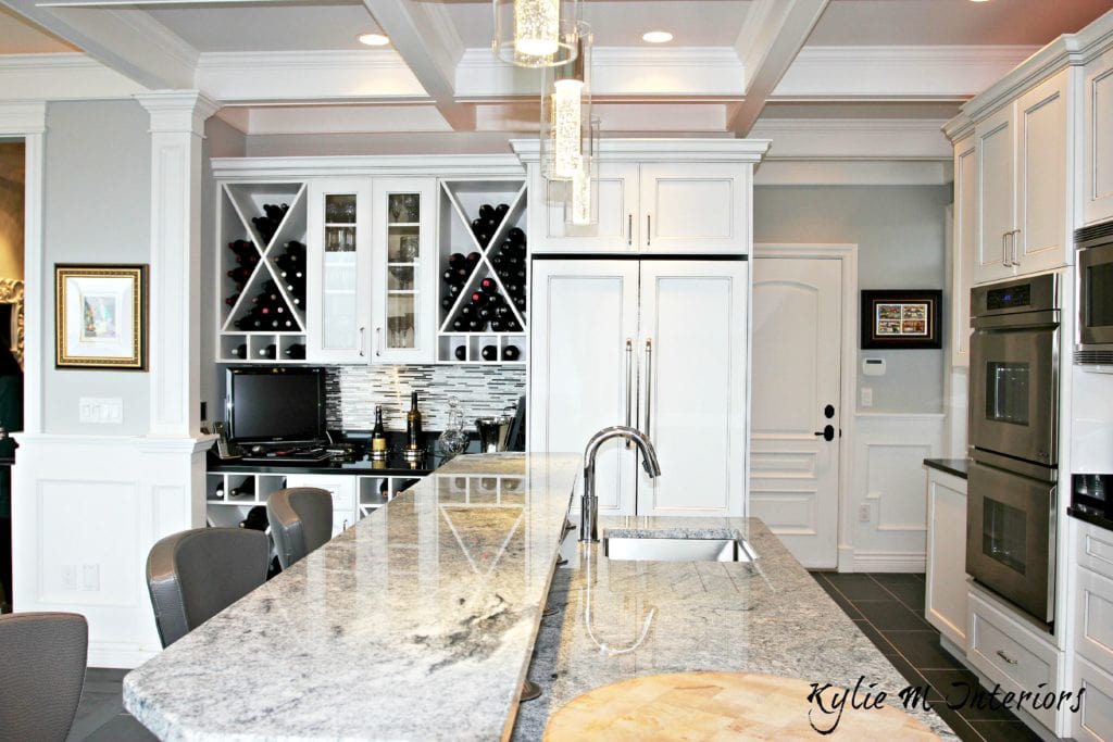 The best gray paint colour to go with marble is Benjamin Moore Stonington Gray. Shown in kitchen with island and white cabinets by Kylie M Interiors