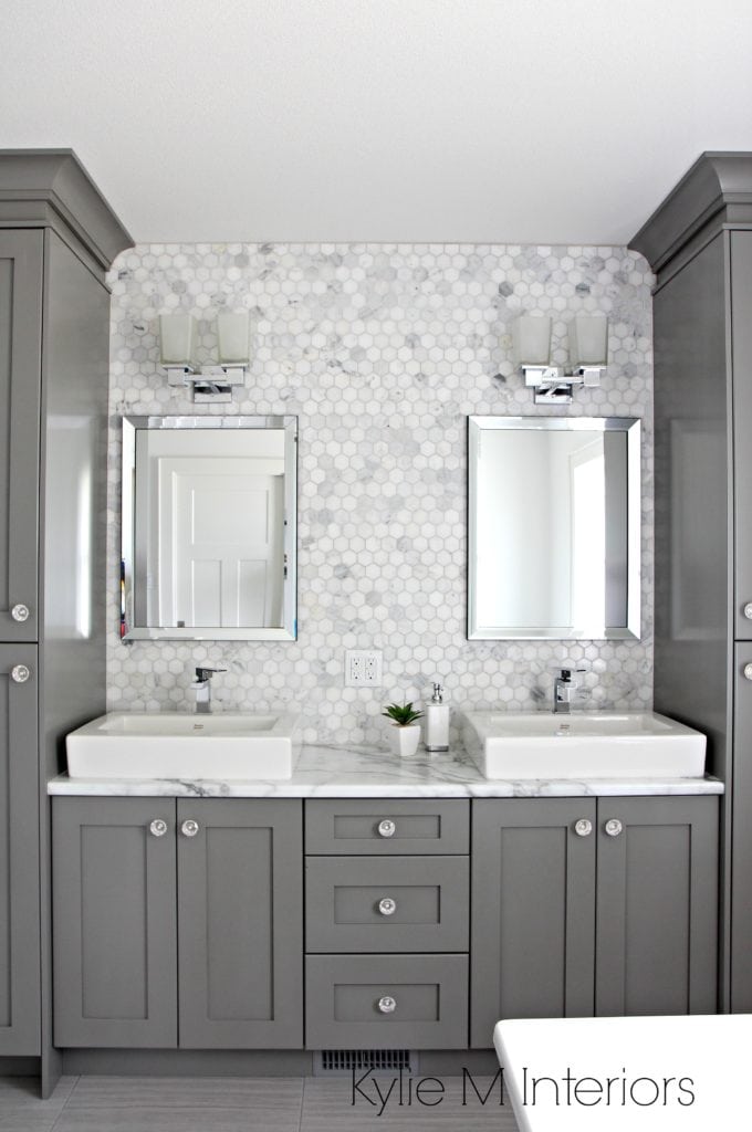 Double vanity in bathroom painted Benjamin Moore Chelsea Gray, hexagon mosaic tile backsplash, Calacatta Marble countertop by Formica. Design by Kylie M Interiors