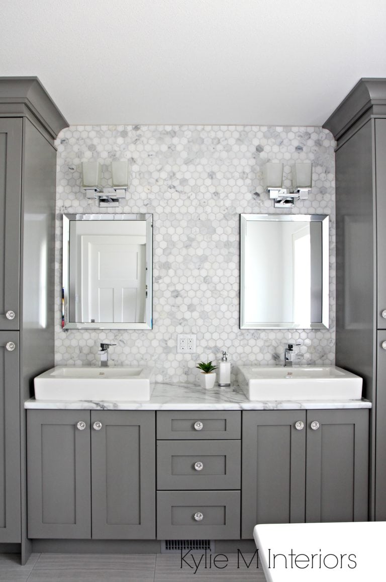 Double vanity in bathroom painted Benjamin Moore Chelsea Gray, hexagon mosaic tile backsplash, Calacatta Marble countertop by Formica. Design by Kylie M Interiors