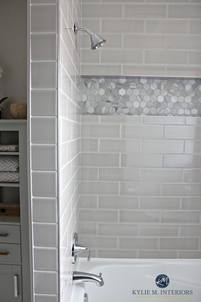 Bathroom with tub remodel with Moen Glyde fixtures, greige and gray subway tile and hexagon marble niche or alcove by Kylie M INteriors