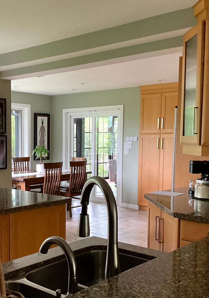 Benjamin Moore October Mist, BEST GREEN PAINT COLOR, White Dove trim, granite countertop, maple orang stain cabinets, beige tile floor.