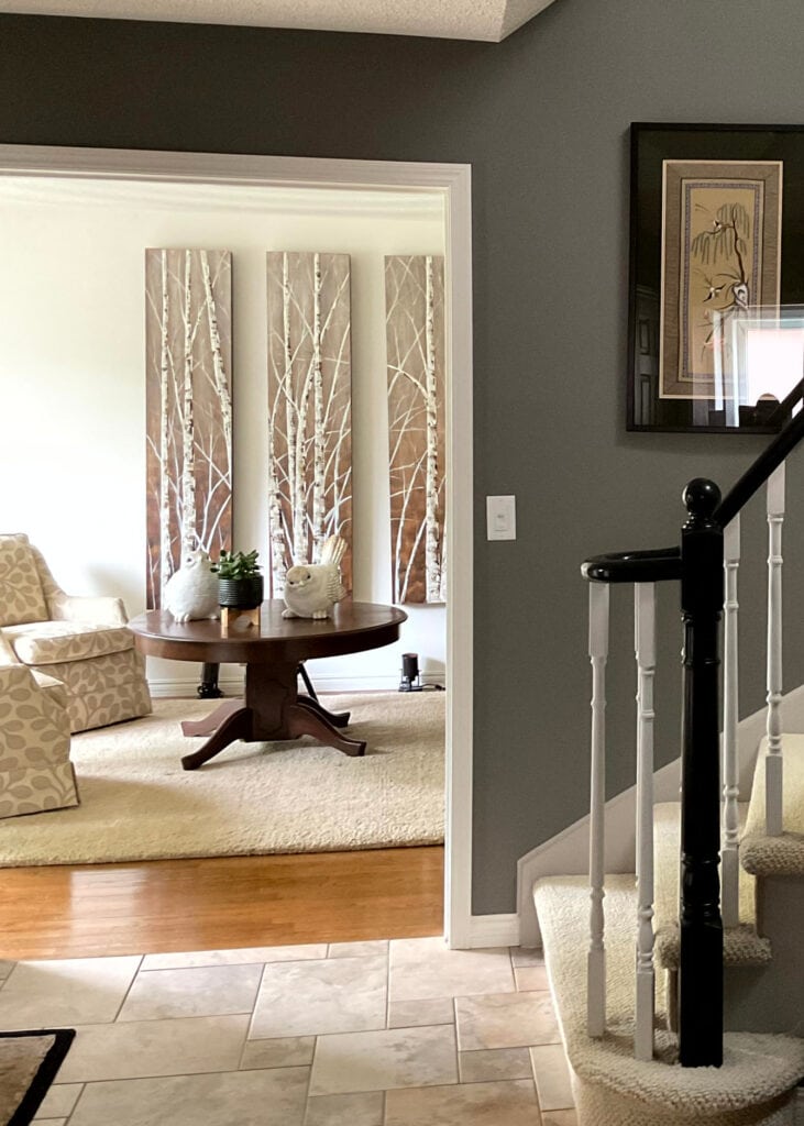 Entryway, beige tile, tan carpet, Benjamin Moore Chelsea Gray paint color on walls, Dove Wing living room, wood floor, black and white stair railing