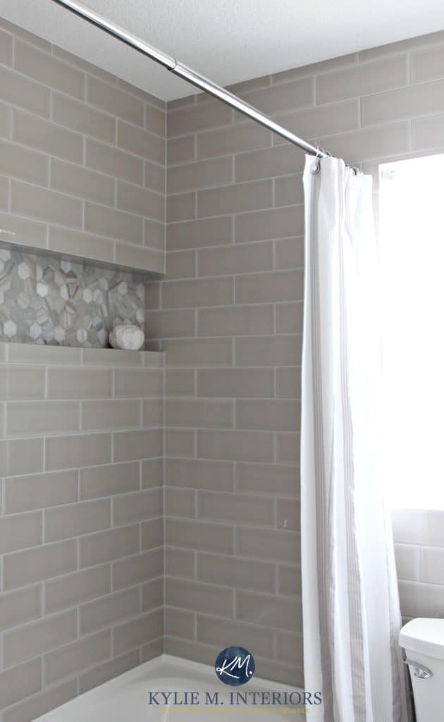 Gray subway tile shower surround with niche or alcove in hexagon shape marble tile for an accent by Kylie M INteriors
