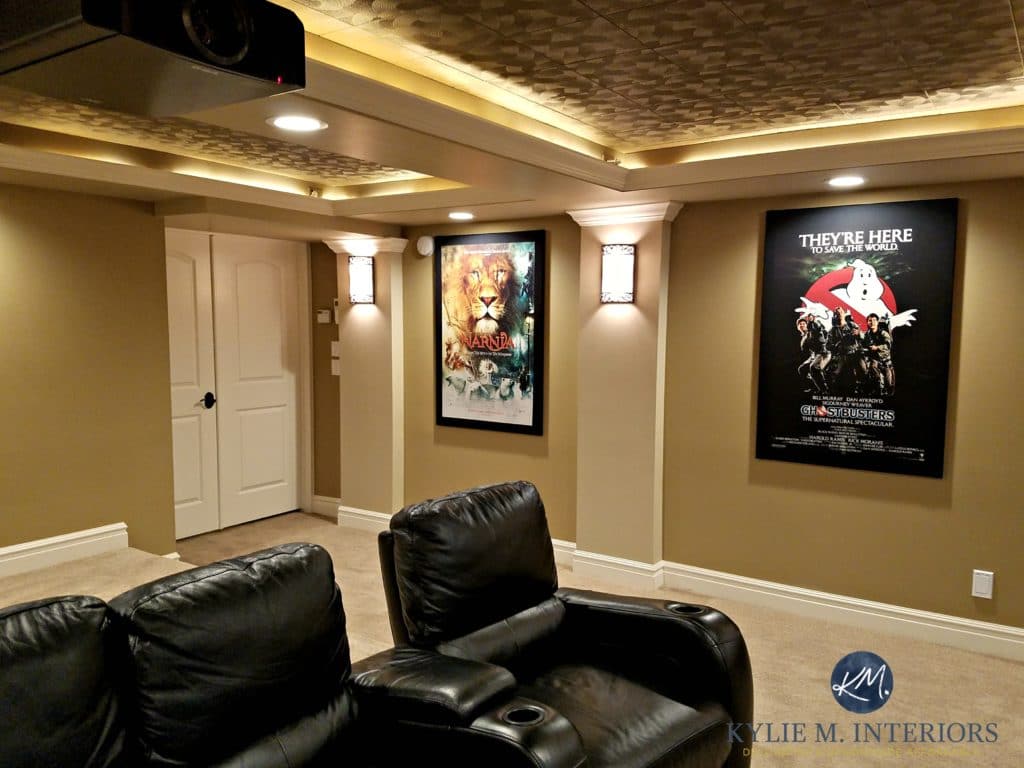 Home theatre room with double doors, black recliners, movie posters, textured acoustic ceiling tiles, wall sconces, BEnjamin Moore Lenox Tan, Davenport Tan and Tyler Taupe. Kylie M interiors E-design