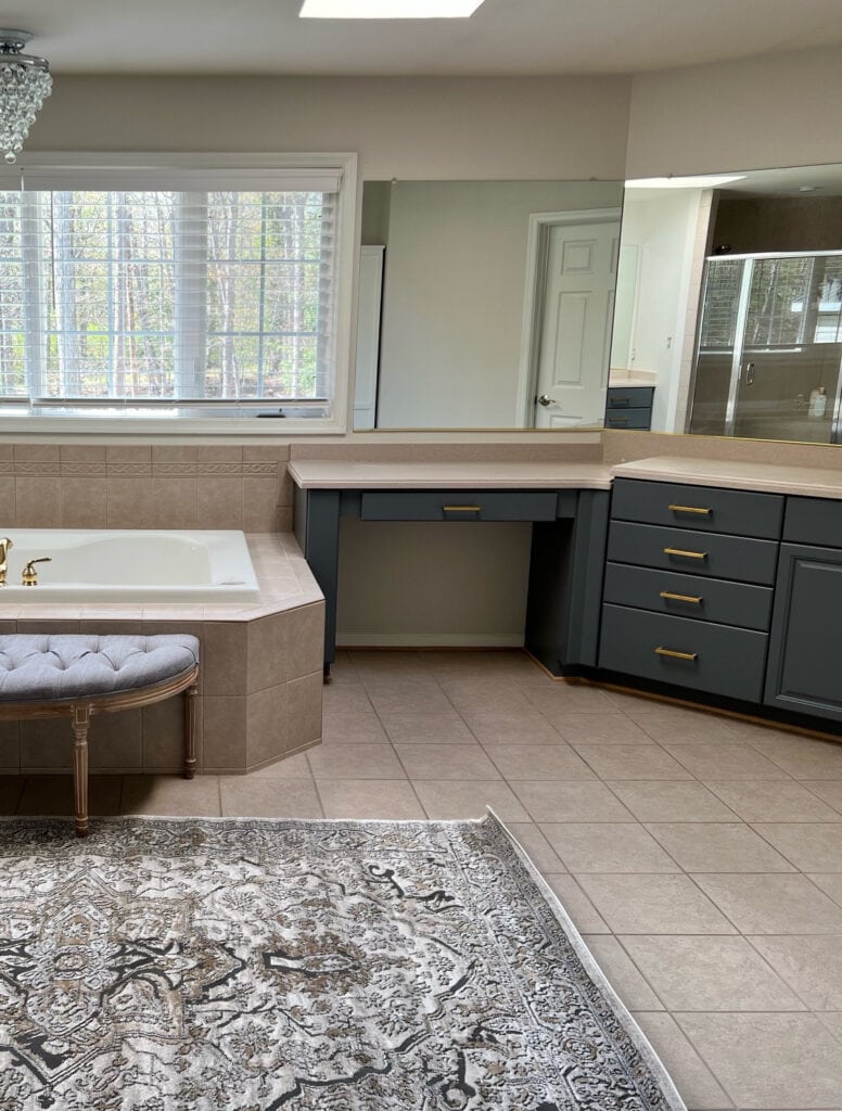 Sherwin Williams Egret White, warm taupe gray walls, beige til 90s, 2000s bathroom update ideas, granite countertop, tiled tub front, wood maple vanity painted
