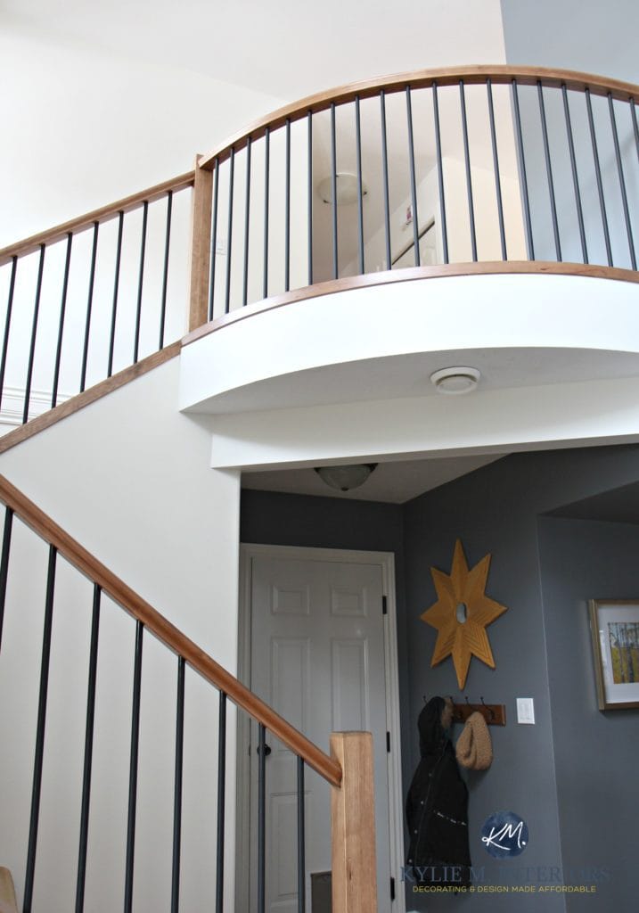 2 storey entryway, foyer and stairwell with wood and metal railing. Sherwin Williams Creamy and Benjamin Moore Steel Wool. Rounded railing