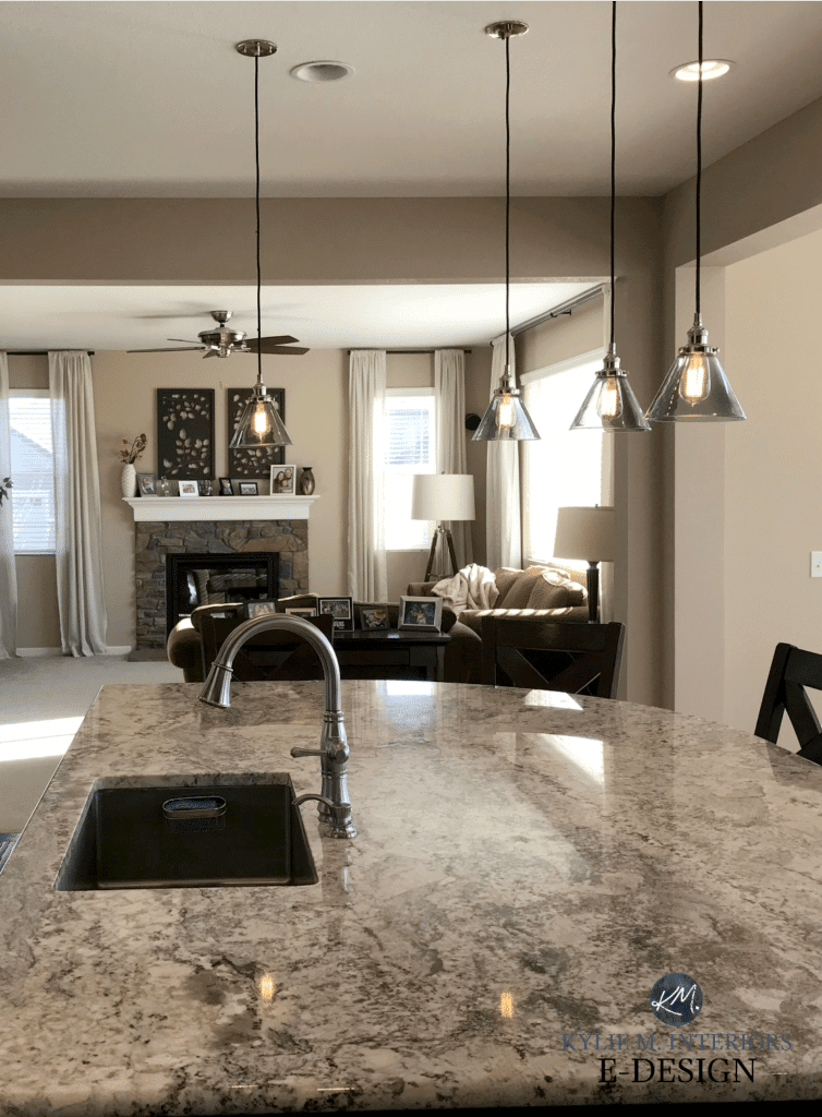 Sherwin Williams Barcelona Beige in open layout kitchen and living room. granite, stone fireplace. Kylie M E-design
