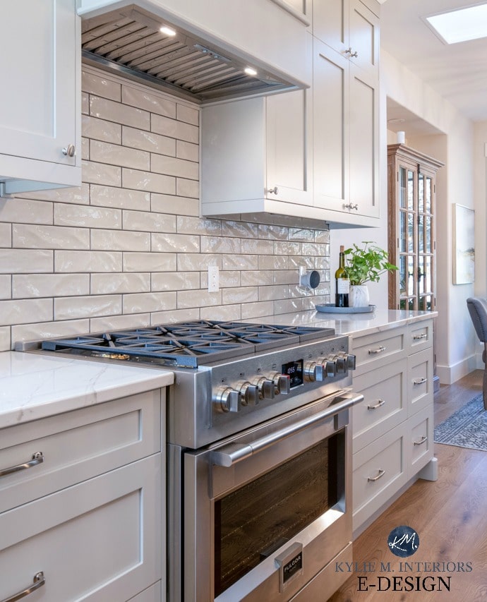 Warm gray painted kitchen cabinets with gray subway tile and dark grout and Fulgor stove in kitchen with white oak flooring. Kylie M Interiors Edesign, online paint colour consulting