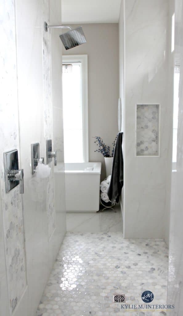 Bathroom with marble walk in shower, hexagon tile floor, alcove, freestanding tub, window. Balboa Mist by Benjamin Moore. Design by Kylie M Interiors. E-decor, online design services