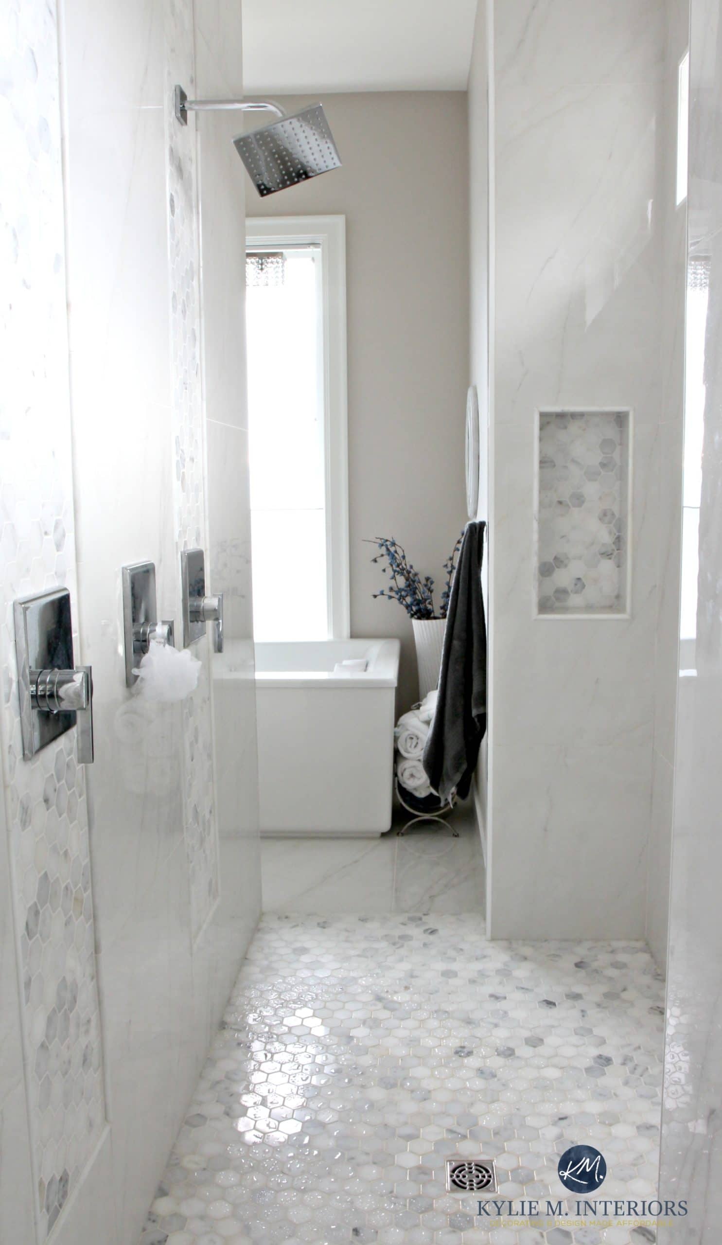 Bathroom with marble walk in shower, hexagon tile floor, alcove, freestanding tub, window. Balboa Mist by Benjamin Moore. Design by Kylie M Interiors. E-decor, online design services