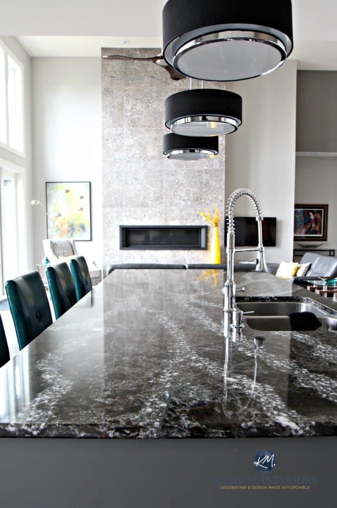 Cambria Ellesmere black quartz island countertop, dramatic pendant lights in contemporary home with tall tiled fireplace with linear gas insert. Kylie M Interiors Decor and Design
