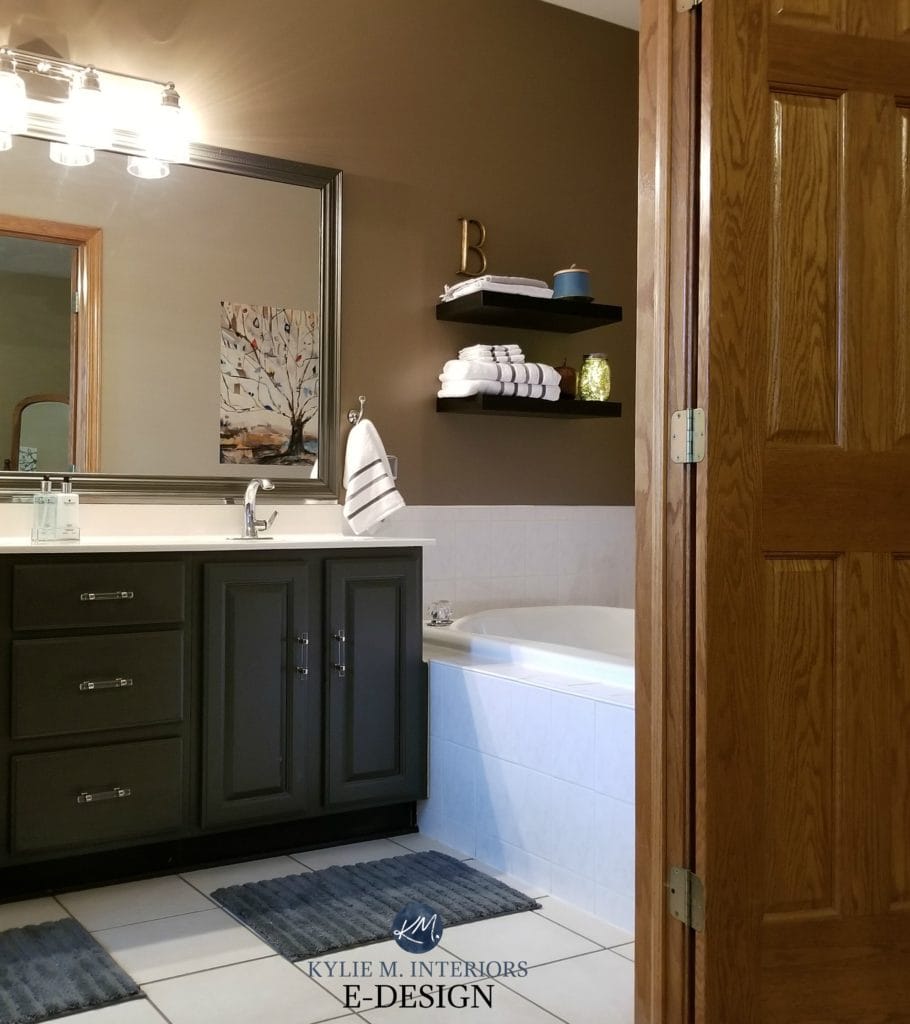 Kylie M Interiors Edesign, oak wood bathroom vanity cabinet painted a dark greige green paint colour by Benjamin Moore, Caramelized Onion by Valspar on walls. Beige tile. DIY decorating ideas