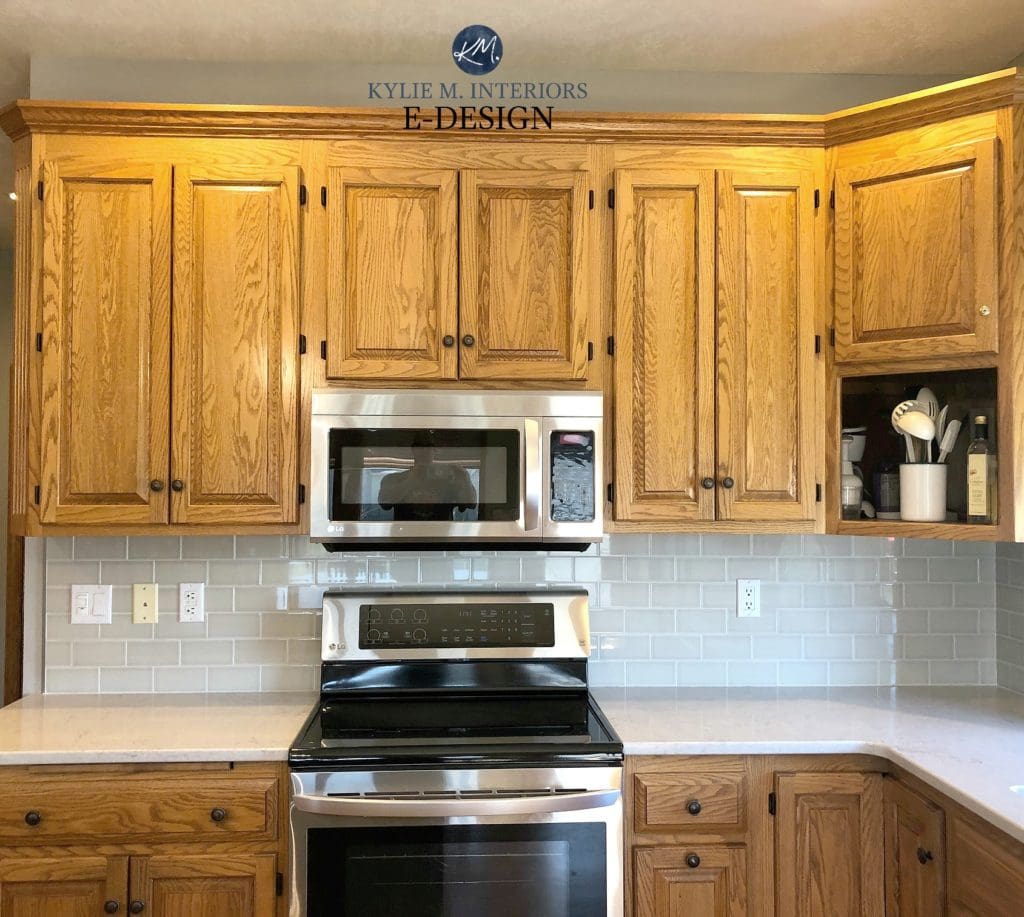 Ideas to update oak or wood kitchen cabinets. Greige subway tile quartz countertop. Kylie M Interiors Edesign, online paint color consulting