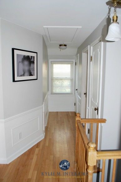 Sherwin Williams Big Chill with white wainscoting, oak flooring and stair railing, white doors in hallway. Kylie M INteriors E-design and Online or virtual color consultant