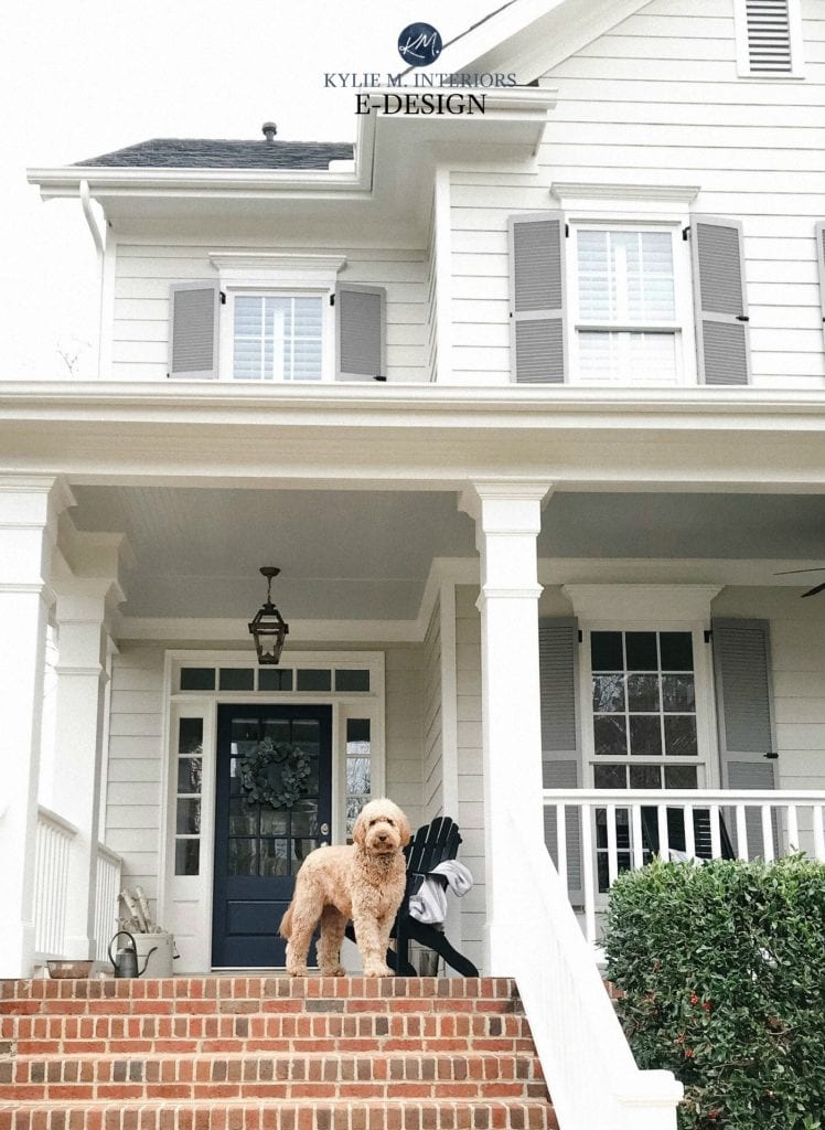 Exterior with gray shutters, warm gray siding (Revere Pewter) Charcoal Slate Navy blue front door and off-white trim. Kylie M Interiors Edesign, shutter colour