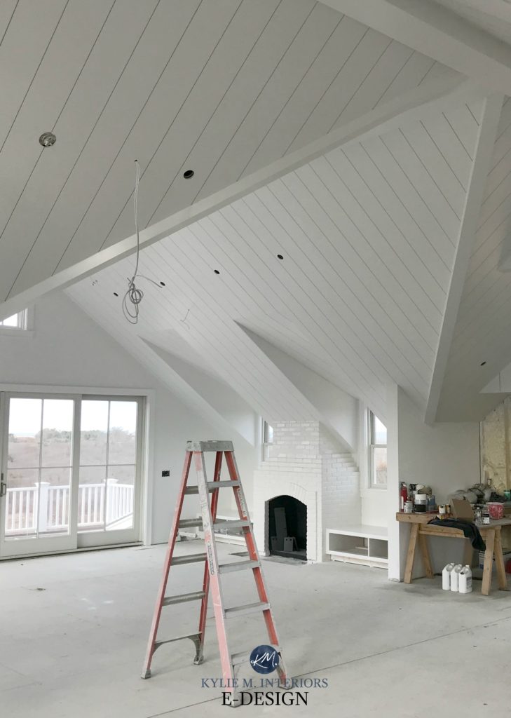 Benjamin Moore White. Open Layout loft style room with shiplap ceiling and painted brick fireplace. Kylie M Interiors Edesign, online paint color consulting