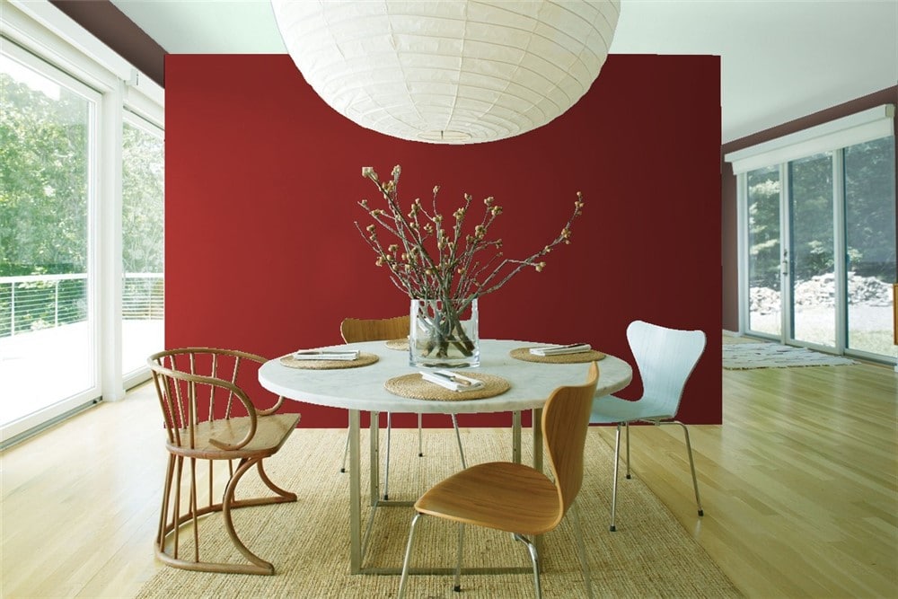 Benjamin Moore Caliente in a dining room as the feature wall wiht light wood flooring. Info via Kylie M E-design. Photo via Benjamin Moore