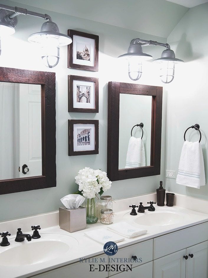 Sherwin Williams Sea Salt in a bathroom with white countertop, vanity, farmhouse bulbs, wood framed mirror. Kylie M E-design, online color consultant