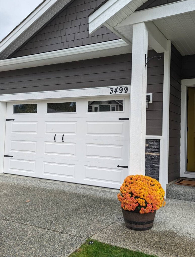 exterior update garage door, white with decorative hardware, handles and hinges. James Hardie siding and shakes shingle in Dark Espresso