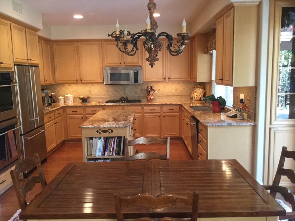 Maple cabinets in kitchen before being painted off-white by Kylie M Interiors E-design