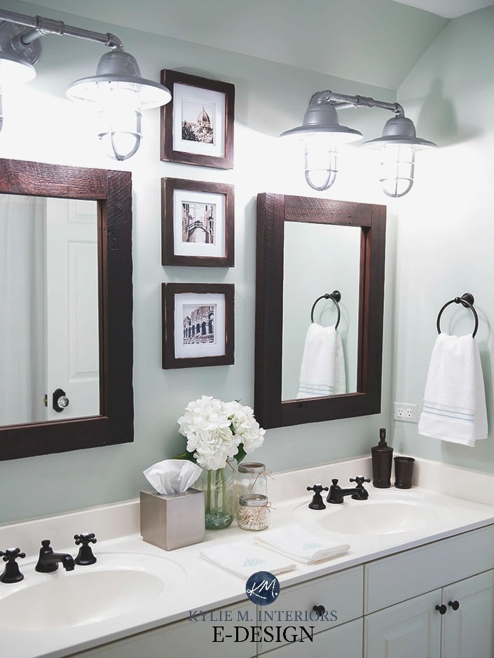 Sherwin Williams Sea Salt in a bathroom with white countertop, vanity, farmhouse bulbs, wood framed mirror. Kylie M E-design, online color consultant