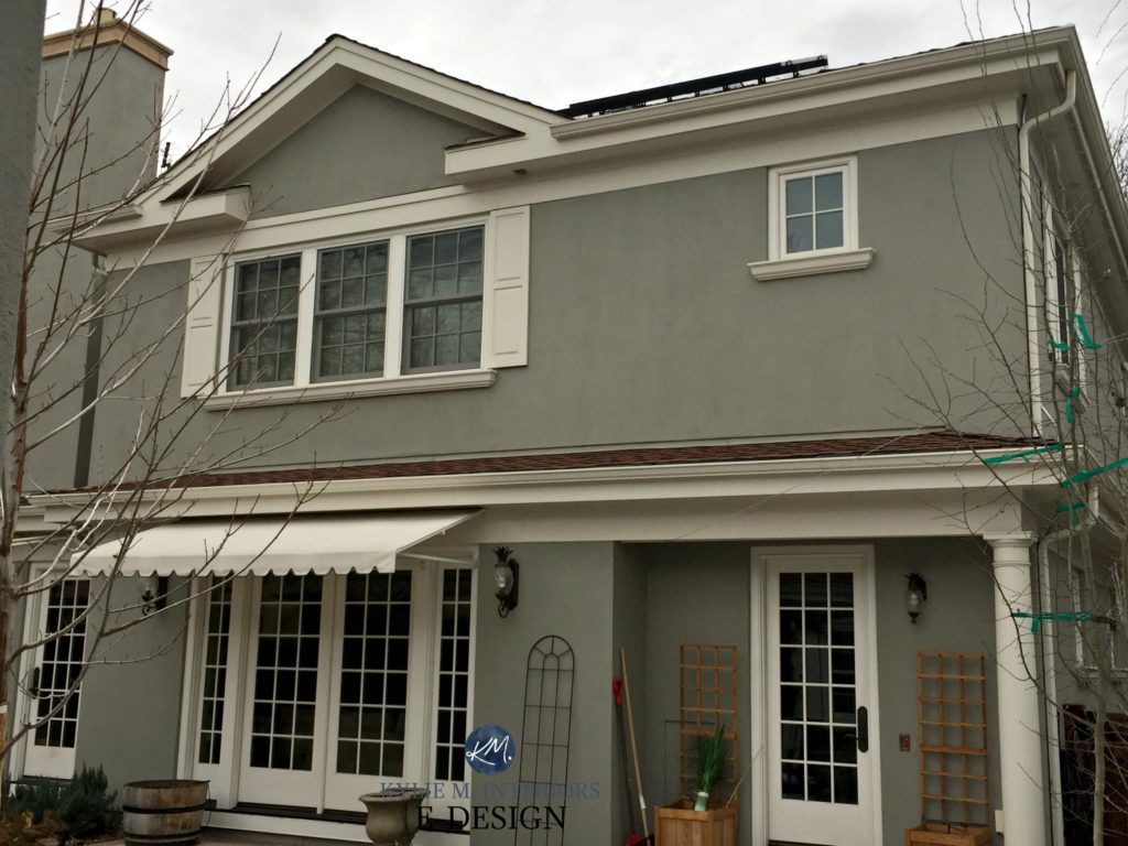 Benjamin Moore Rockport Gray exterior paint with cream trim BM Sail Cloth and shutters on cloudy day. Kylie M Interiors CLIENT photo before