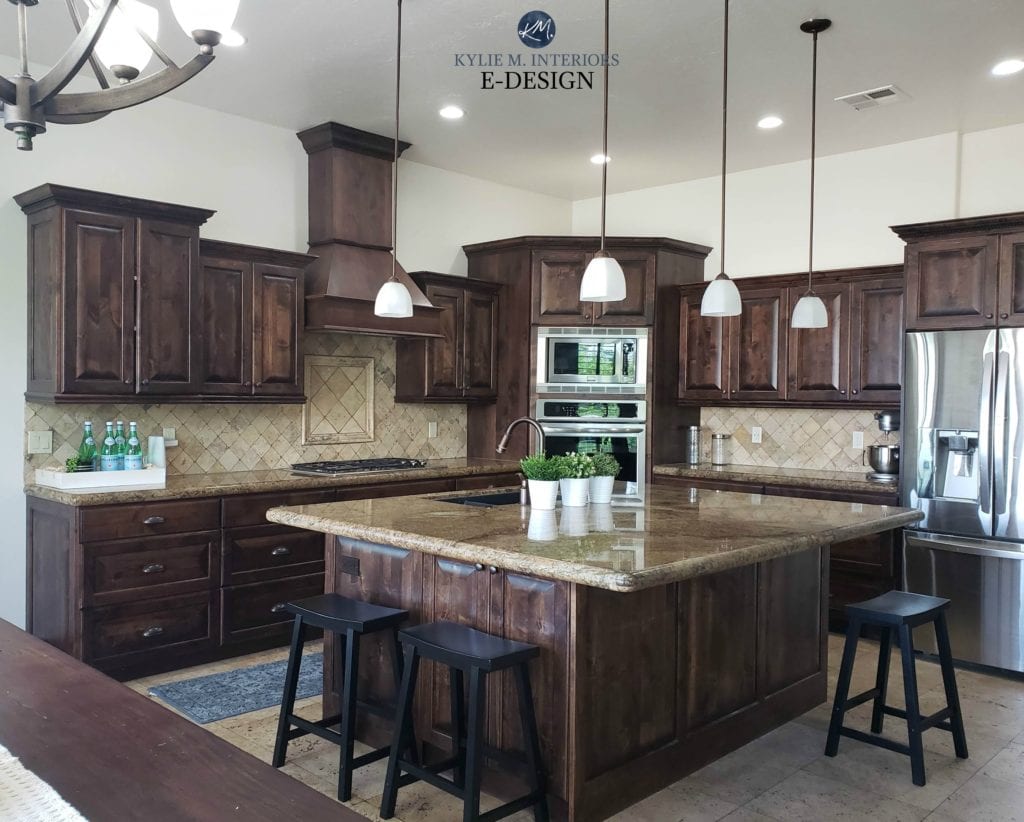 Dark wood kitchen cabinets and trim with travertine tile backsplash and warm granite. Sherwin Williams White Duck darkened on walls. Kylie M Interiors Edesign, online paint color advice blog