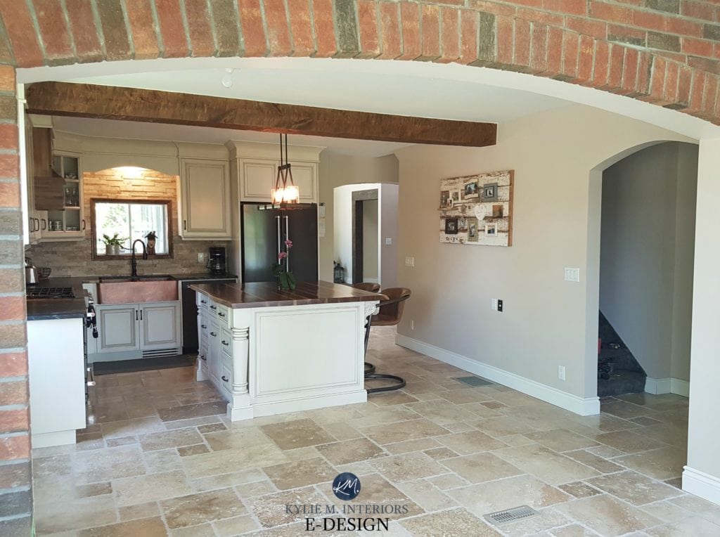 Kitchen cabinets painted Benjamin Moore Ballet White, glaze, Cedar Key walls, travertine tile floor , red orange brick walls. Island with wood top. Kylie M Interiors Edesign, client photo (1)