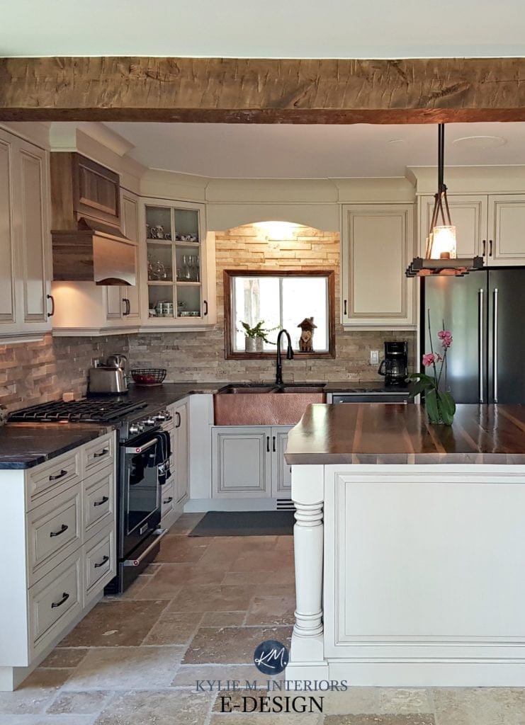 Kitchen cabinets painted Benjamin Moore Ballet White, glaze, Cedar Key walls, travertine tile floor , red orange brick walls. Island with wood top. Kylie M Interiors Edesign, client photo 