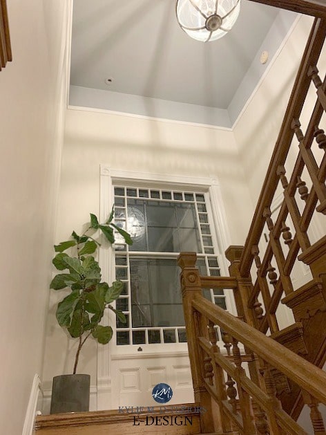 Dark wood stair railing and trim with Ballet White walls and Coventry gray painted ceiling with book rail and moldings. Kylie M Interiors Edesign, online paint color consulting, DIY decorating