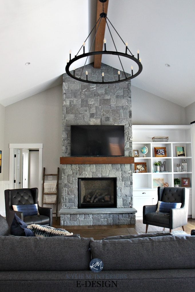 Living room, gray stone fireplace, round wheel chandelier, white built in bookcases, Stonington Gray paint colour. Kylie M Interiors Edesign, online paint color expert