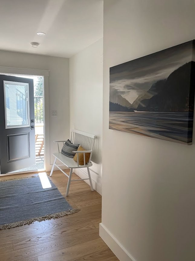 Benjamin Moore White Dove in a dark hallway, best white paint color, white trim, oak floor, dark inside of the door. KYlie M Edesign
