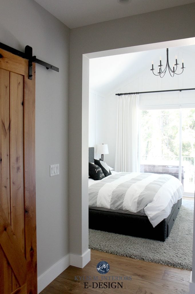 Farmhouse white bedroom with board and batten, wood floor, gray, white black palette with chandelier and drapes. Kylie M Interiors Edesign, online paint color and blogger