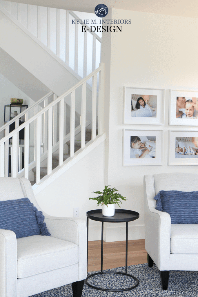 Kylie M Interiors E design, online paint colour consulting. Sherwin Williams Pure White walls, trim and railings in south facing room with open staircase. Navy blue accents and home decor