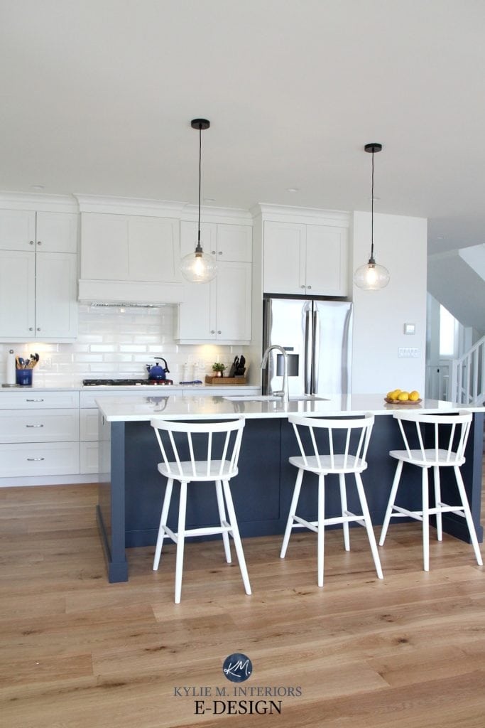Kylie M Interiors Edesign, online paint colour consultant. Island in navy blue, Cyberspace, Pure White cabinets, bevelled white subway tile backsplash, white cabinets in the kitchen
