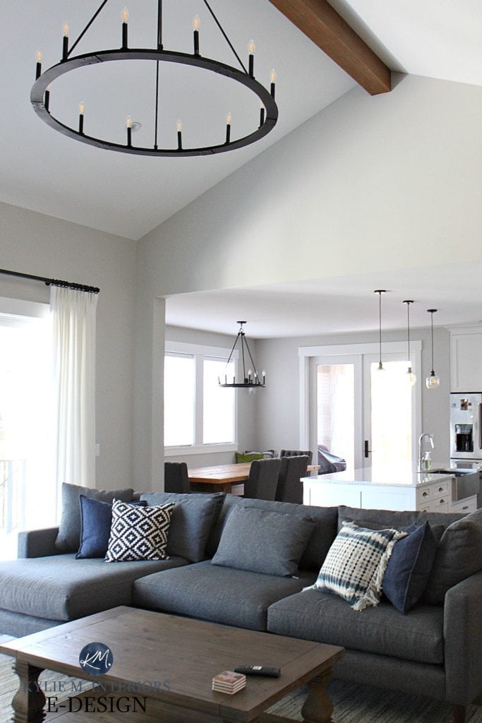 Open layout living room, kitchen and dining room, vaulted ceiling with beam and chandelier. Stonington Gray paint colour. Gray sectional, Kylie M Interiors Edesign online paint color consulting